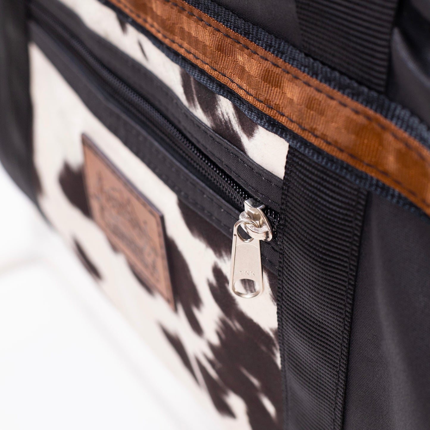 Black Canvas Travel Bag with limited edition cow print fabric.