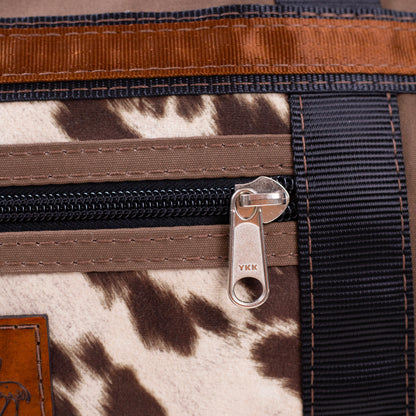 Antelope Brown Overnight Canvas Bag with limited edition cow print fabric up close of zip.